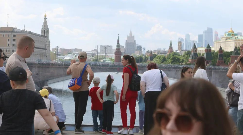 People rest outside the Kremlin on a warm summer day in downtown Moscow, Russia, 05 June 2026. EPA/MAXIM SHIPENKOV
