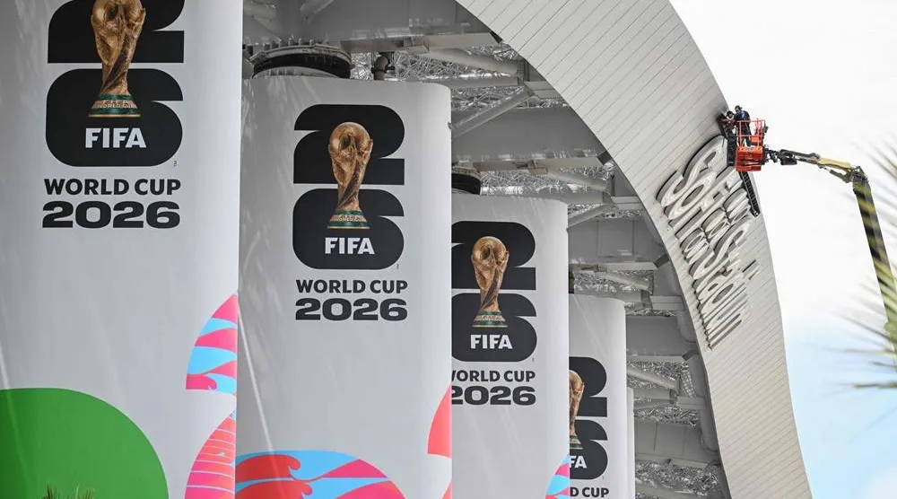 Workers are seen on a crane at Los Angeles Stadium (temporarily renamed from SoFi Stadium) ahead of the 2026 FIFA World Cup in Los Angeles on June 7, 2026. (AFP)