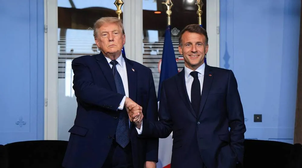 US President Donald Trump (L) shakes hands with France's President Emmanuel Macron during a bilateral meeting on the sidelines of the G7 summit, in Evian, central-eastern France on June 15, 2026. (AFP)