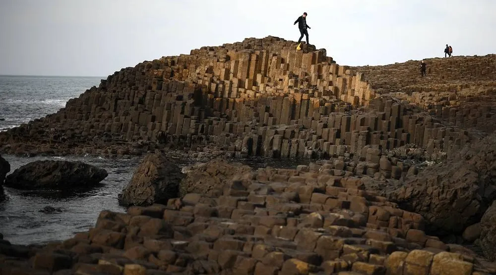 People explore the basalt columns of the Giant’s Causeway on Northern Ireland’s north coast on March 20, 2025. (AFP via Getty Images) 