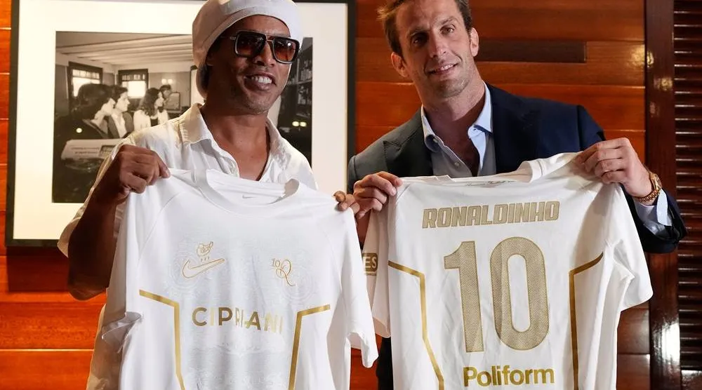 Brazilian football legend Ronaldinho, left, holds up jerseys along with Ignazio Cipriani, president of Ravenna FC, at a media event celebrating Ronaldinho's recent signing with the Italian club, at Cipriani Downtown Miami restaurant, Tuesday, June 23, 2026, in Miami. (AP) 