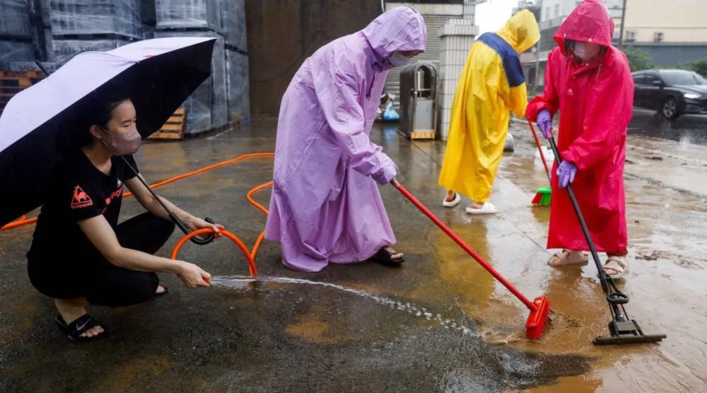  People clean mud and debris from a flooded area after heavy rain brought by Tropical Storm Mekkhala in Hsinchu, Taiwan, June 26, 2026. (Reuters)