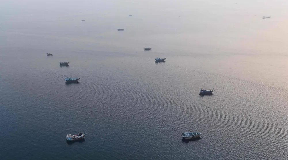 This aerial photograph shows boats anchored off Oman's northern Musandam Peninsula near the Strait of Hormuz on June 27, 2026. (Photo by AFP)  