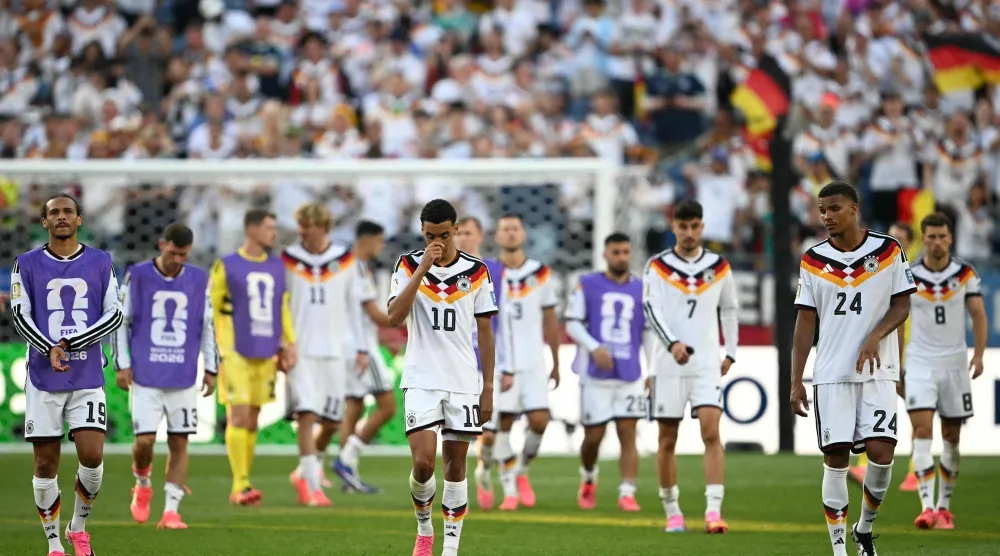 (From L) Germany's forward #19 Leroy Sane, midfielder #10 Jamal Musiala and defender #24 Malick Thiaw react after losing the penalty shootout during the 2026 World Cup round of 32 football match between Germany and Paraguay at the Boston Stadium in Foxborough on June 29, 2026. (AFP) 