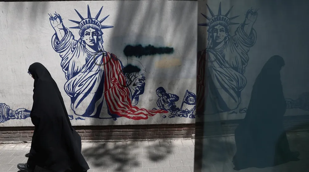 A woman walks past an anti-US mural on a street in Tehran, Iran, June 1, 2026. Majid Asgaripour/WANA (West Asia News Agency) via Reuters 