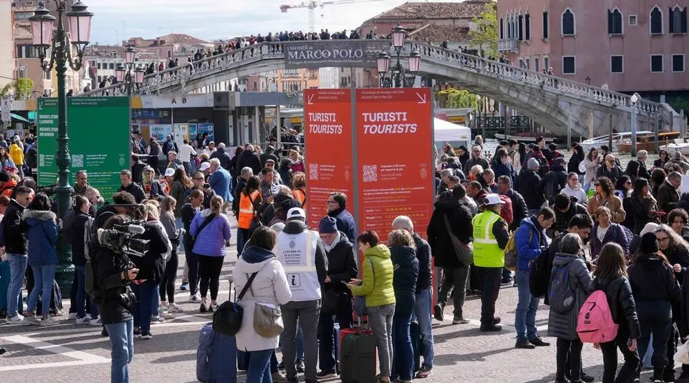 Stewards check tourists QR code access outside the main train station in Venice, Italy, on April 25, 2024. (AP)