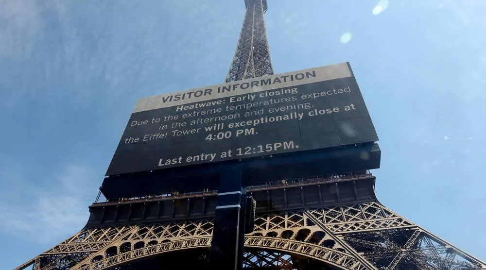  A sign informs visitors that the Eiffel Tower will close at 16:00 CEST today due to extreme temperatures during a heatwave in Paris, France, July 11, 2026. (Reuters)