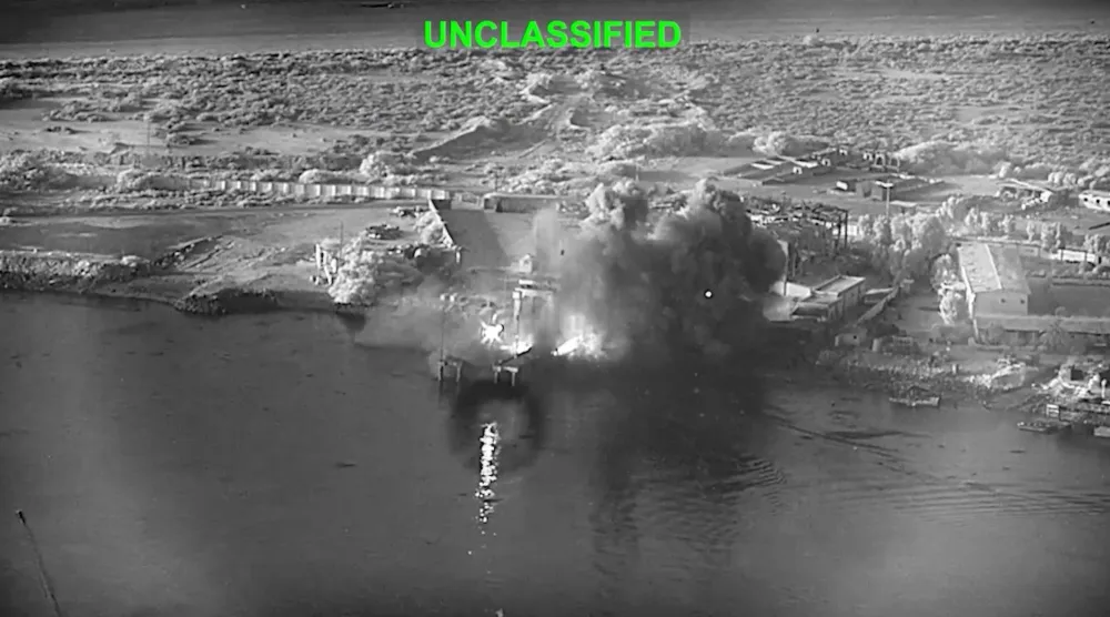  This image from video released by US Central Command, shows an explosion at Bandar Abbas Naval Base, Iran, as three Corsair unmanned surface vessels, also called one-way attack surface drones, fired by the US military, hit the port July 12, 2026. (US Central Command via AP) 