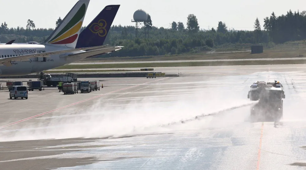 A vehicle from Oslo Airport’s fire rescue services sprays water onto the runway at the airport, to combat heat, in Oslo, Norway, July 15, 2026. REUTERS/Tom Little