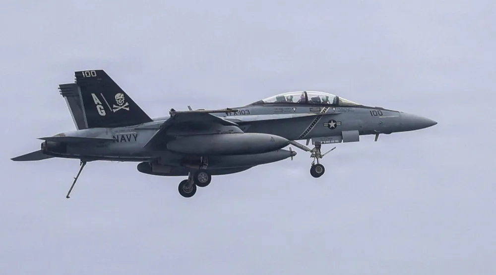This US Navy handout photo released on July 10, 2026 and taken on June 29 by US Central Command Public Affairs shows an F/A-18F Super Hornet, attached to Strike Fighter Squadron (VFA) 103, preparing to land on the flight deck of Nimitz-class aircraft carrier USS George H.W. Bush (CVN 77). (US Navy/AFP)