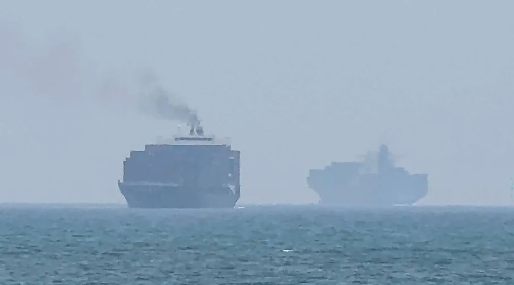 TOPSHOT - This frame grab taken from AFPTV video footage on July 12, 2026 shows cargo ships anchoring near the Strait of Hormuz off the eastern coast of the United Arab Emirates at Khor Fakkan. (Photo by AFPTV / AFP)