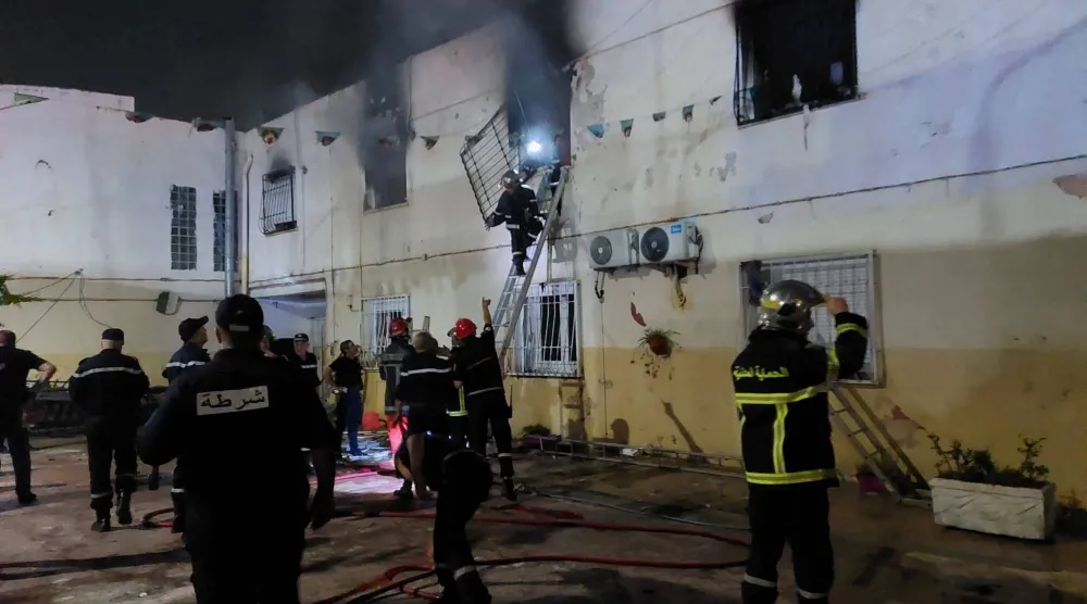 قوات الإطفاء خلال محاولة إخماد الحريق الذي أودى بحياة 11 شخصاً (رويترز)