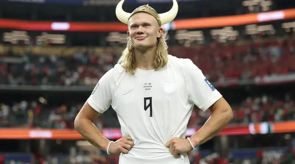 Erling Haaland wears a viking helmet after beating the Ivory Coast at the World Cup. (Getty Images)