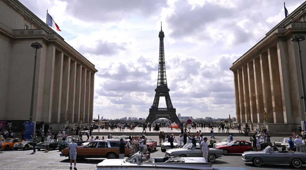 Participants park their car at the Trocadero, with the Eiffel Tower seen in the background, during the 19th Summer parade of vintage vehicles in Paris on July 19, 2026. (AFP)