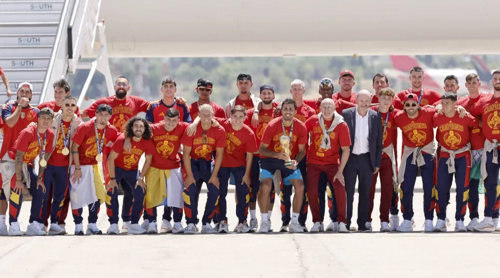 Spain's team pose with their trophy on the tarmac upon their arrival from the US after winning the 2026 World Cup, in Madrid Barajas' airport, on July 20, 2026. (AFP)