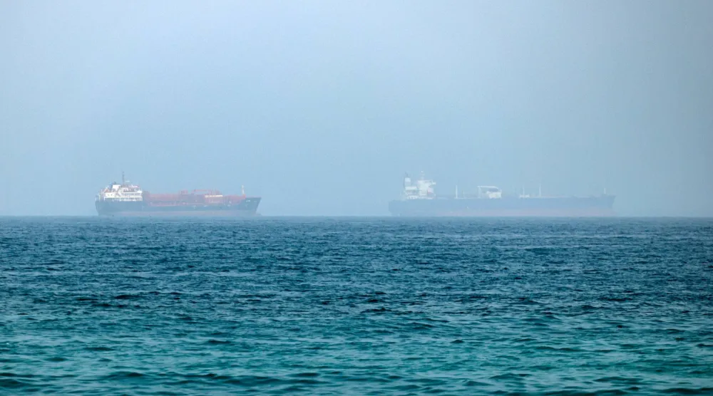 Cargo vessels are seen at one end of the Strait of Hormuz near the coast of Dibba Al Fujairah, United Arab Emirates, 21 July 2026.  EPA/STRINGER