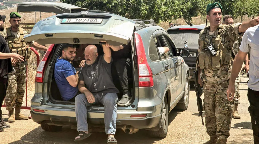 نازحون من بلدة زوطر يعودون إليها بعد انتهاء الجيش اللبناني من الانتشار فيها أمس (د.ب.أ) 