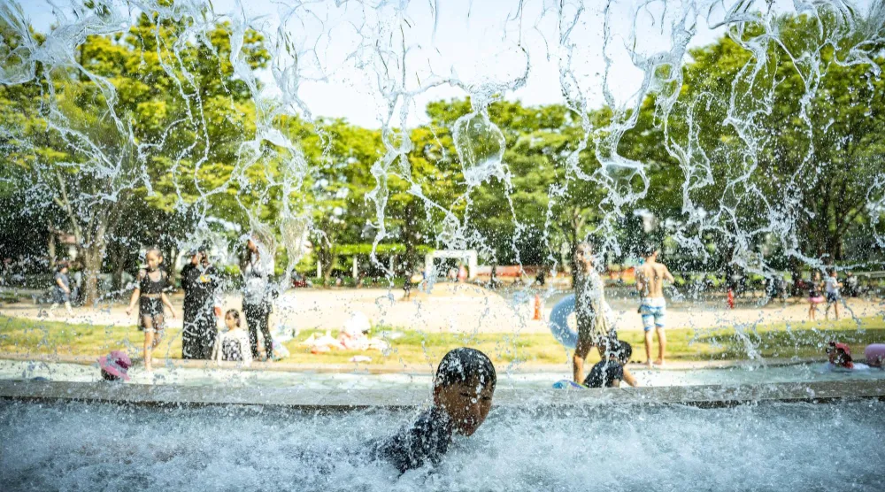  A child cools off in a public water playground at a park in Edogawa district of Tokyo on July 23, 2026. (AFP) 