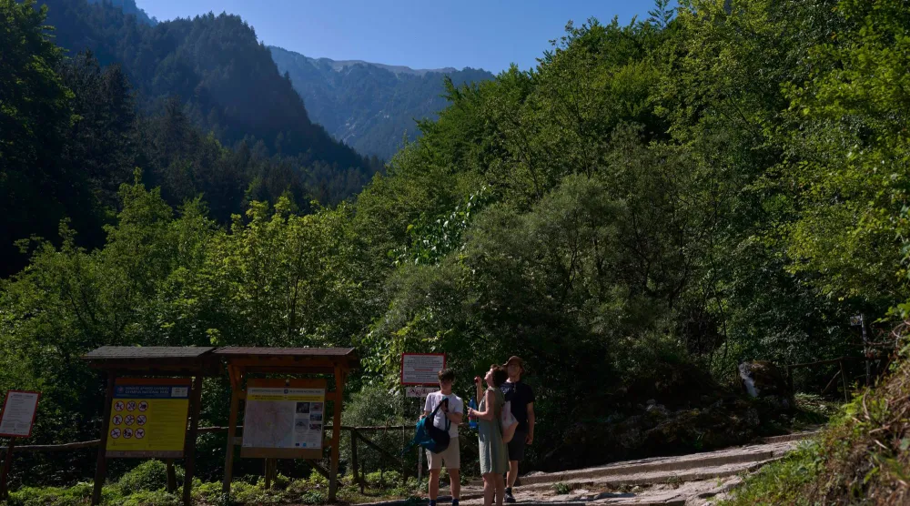 Visitors stand at the Prionia trailhead on Mount Olympus in northern Greece, Wednesday, July 15, 2026. (AP Photo/Petros Giannakouris)