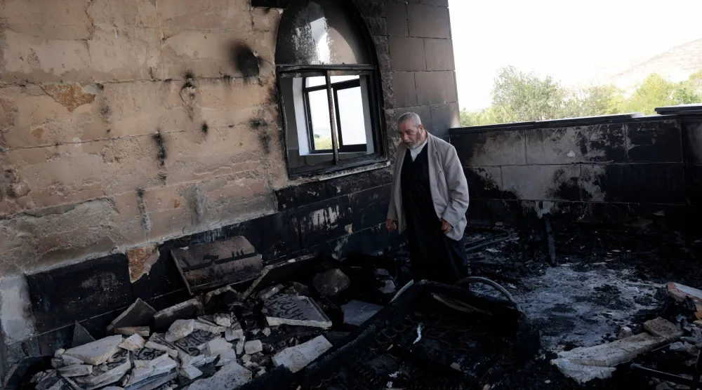 A Palestinian man inspects the damage at a mosque, which Palestinians say was damaged by Israeli settlers, in Qusra near Nablus, in the Israeli-occupied West Bank, July 26, 2026. REUTERS/Mohamad Torokman