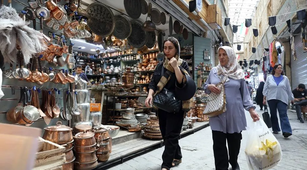 Iranians shop at a bazaar in Tehran, Iran, 27 July 2026. (EPA)