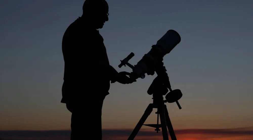 Retired shepherd and self-taught astronomer Joaquin Tapioles disassembles one of his telescopes outside the farming village of San Agustin del Pozo, Spain, July 22, 2026. REUTERS/Violeta Santos Moura