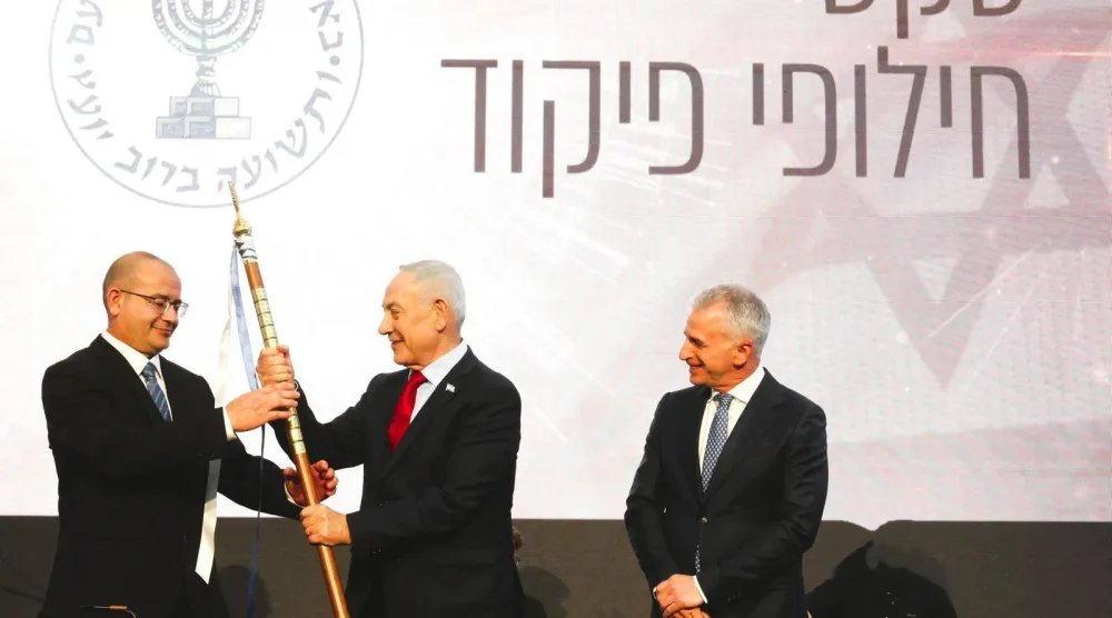 The new head of Israel's Mossad, Roman Gofman (left), receives a symbolic insignia during his inauguration as agency chief from Prime Minister Benjamin Netanyahu, with outgoing head David Barnea in attendance (X)