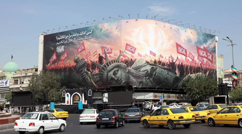 Vehicles drive past an anti-US billboard at Enghelab Square in central Tehran, Iran, 09 August 2026. EPA/ABEDIN TAHERKENAREH 