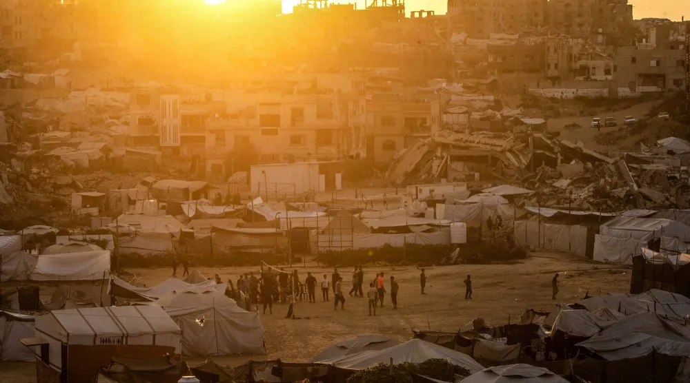 Displaced Palestinian youths play volleyball between destroyed houses in Jabaliya, northern Gaza City, 07 August 2026. (EPA)