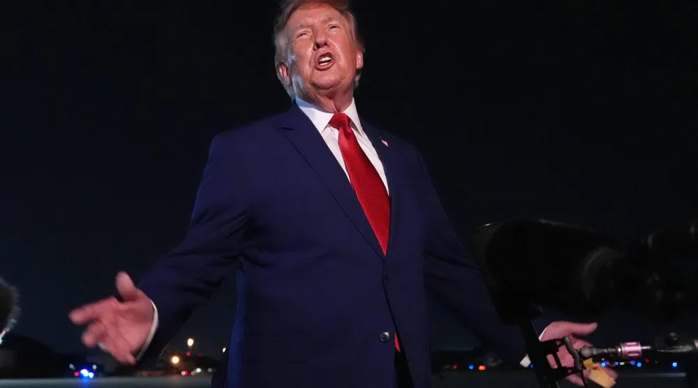  President Donald Trump talks to reporters after arriving on Air Force One Tuesday, Aug. 11, 2026, at Joint Base Andrews, Md. (AP) 
