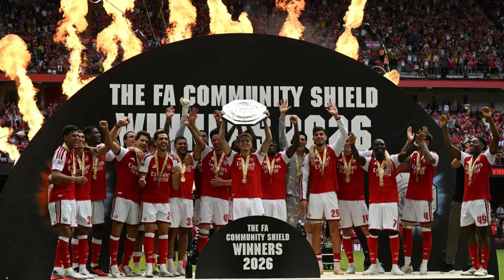 Arsenal's Norwegian midfielder #08 Martin Odegaard lifts the trophy as Arsenal's players celebrate their victory after the English FA Community Shield football match between Arsenal and Manchester City at The Principality Stadium, in Cardiff, south Wales on August 16, 2026. (AFP)
