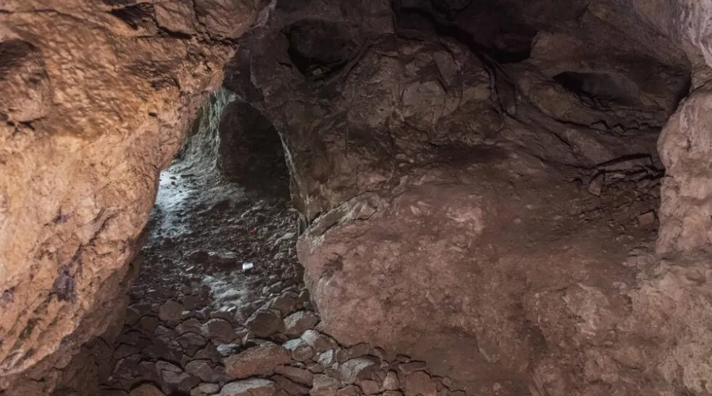 Access to the rock-strewn cave is not easy. Ahmet Ayberk Cimen / AFP
