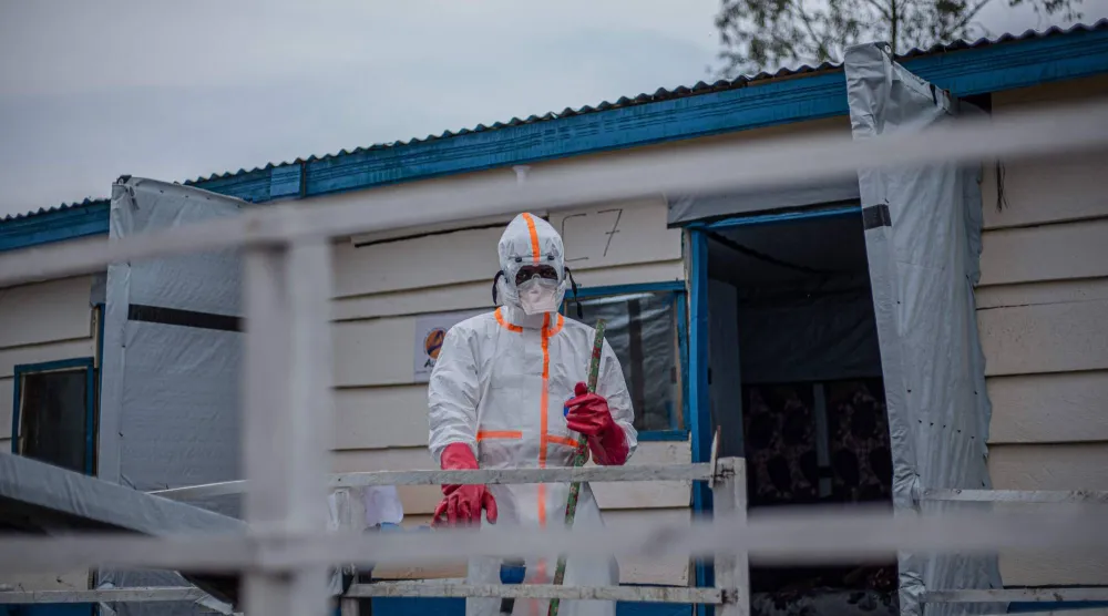 A hygienist wearing personal protective equipment (PPE) begins cleaning and disinfection operations at the Rwampara Ebola Treatment Center (ETC) in Bunia, Ituri, in the east of the Democratic Republic of Congo on July 13, 2026. (Photo by BENEDICTION MURHABAZI / AFP)
