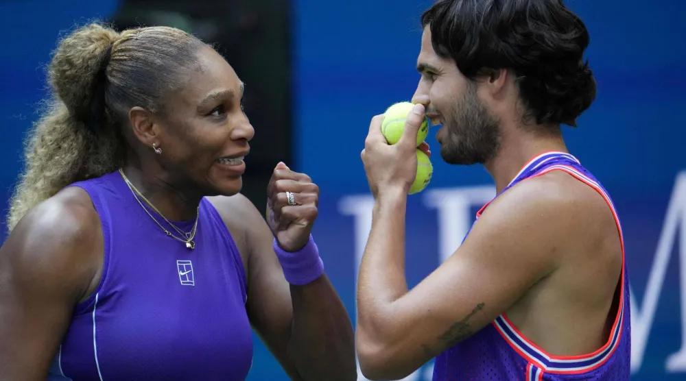 USA's Serena Williams and Spain's Carlos Alcaraz confer during their mixed doubles tennis match against Switzerland's Belinda Bencic and Italy's Flavio Cobolli at the 2026 US Open tennis tournament at the USTA Billie Jean King National Tennis Center in New York, on August 25, 2026. (AFP) 