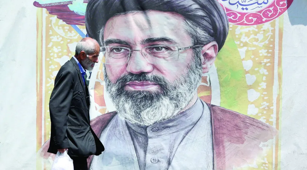 An Iranian man walks past a poster of Iranian supreme leader Mojtaba Khamenei in a street in Tehran, Iran, 18 June 2026. EPA/ABEDIN TAHERKENAREH 