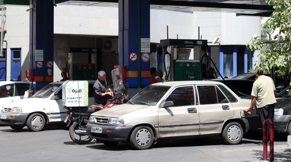 An Iranian fills up at a petrol station in Tehran, Iran, 25 August 2026. (EPA)