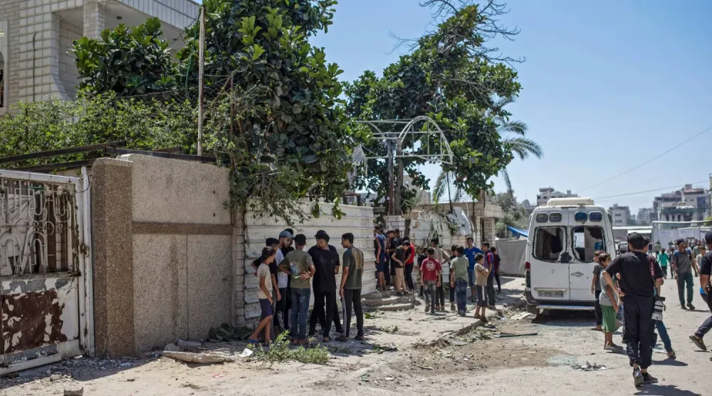 İsrail tarafından dün saldırıya uğrayıp kaçırılan Hamas güvenlik görevlisinin evinin yakınlarındaki Filistinliler (EPA)