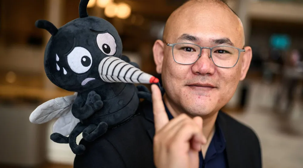 Canadian Associate Professor Changhong Cao poses with a fake mosquito ahead of the 2026 Ig Nobel Prize Ceremony in Zurich, on September 3, 2026. (AFP)