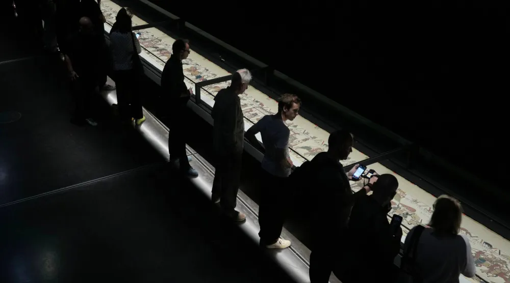  The 70-meter-long Bayeux Tapestry is displayed during a press preview at the British Museum in London after returning to England, following a historic agreement between the UK and France, Monday, Sept. 7, 2026. (AP) 