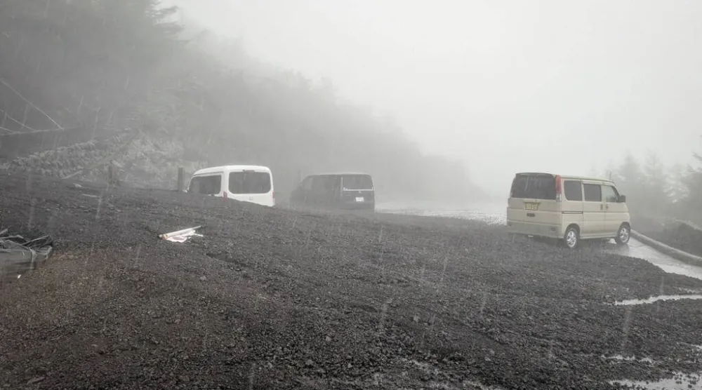Vehicles buried by mud and debris after a landslide swept into the parking lot at Fifth Station of Mount Fuji's Fujinomiya Trail. Shizuoka Prefecture/AFP
