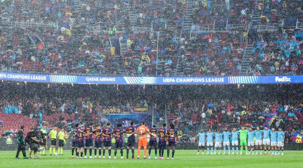  Players observe a minute of silence in remembrance of the victims of the recent devastating floods in Nepal, before the start of the UEFA Champions League first round day 1 football match between FC Barcelona and Feyenoord at Camp Nou stadium in Barcelona on September 9, 2026. (AFP)