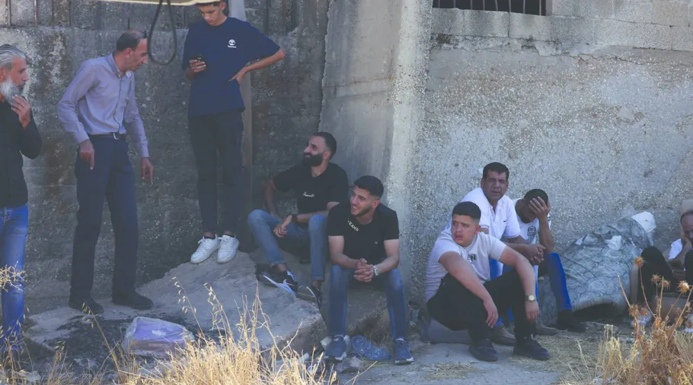 
فلسطينيون ينتظرون عبور حاجز عسكري شرق نابلس بالضفة الغربية أمس (إ.ب.أ)