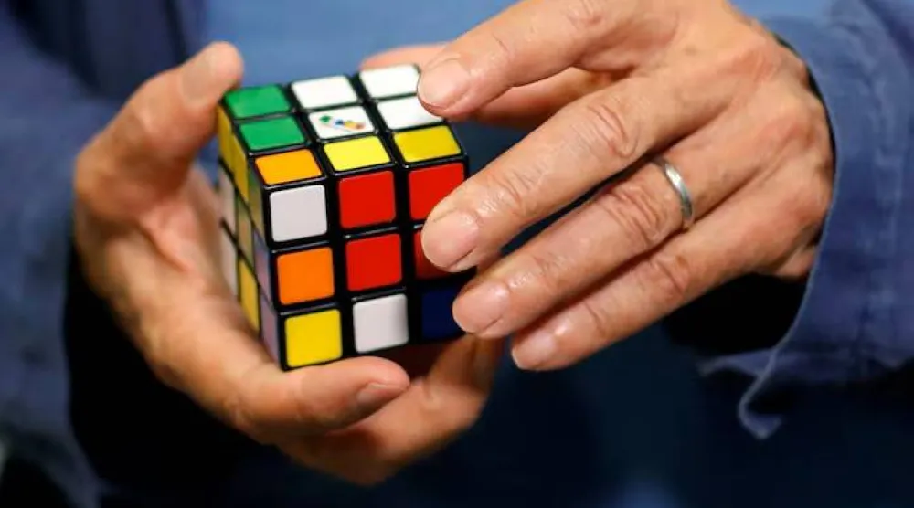 Erno Rubik, the creator of the puzzle, solves a Rubik's cube as he poses during the world's largest Rubik's Cube championship in Aubervilliers, near Paris, France, July 15, 2017. REUTERS/Stephane Mahe/File Photo