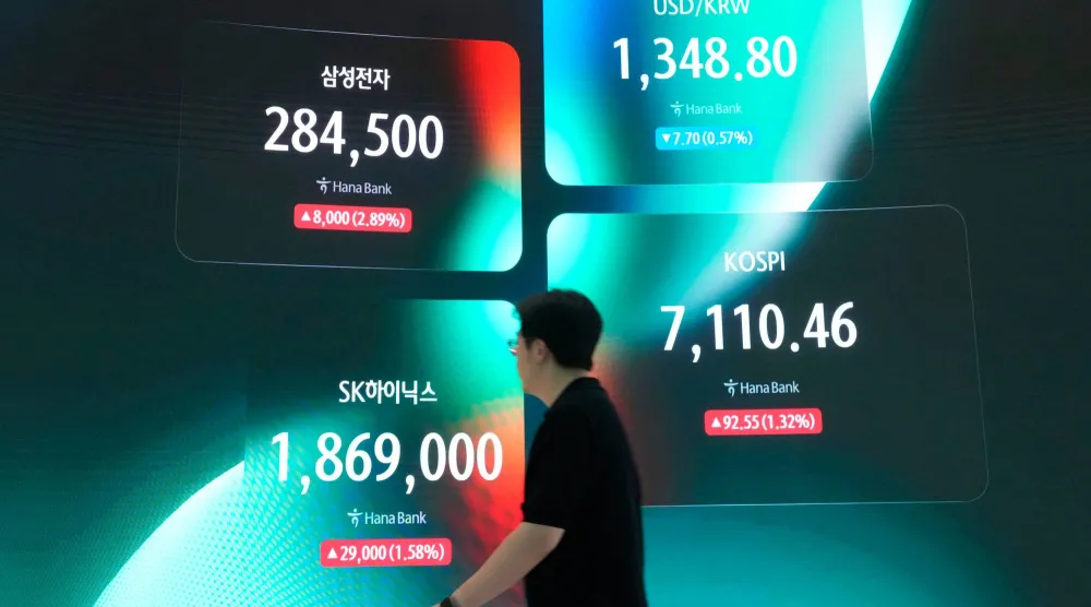 شاشة تعرض مؤشر «كوسبي» وسعر صرف العملات الأجنبية بين الدولار الأميركي والوون، وسعر أسهم شركتي «سامسونغ» و«إس كيه هاينكس» في سيول (أ.ب)