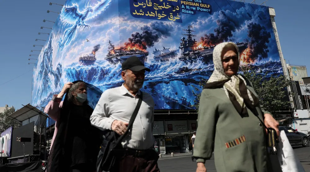 People walk past a billboard about the Strait of Hormuz, on a building in Tehran, Iran, September 16, 2026. Majid Asgaripour/WANA (West Asia News Agency) via Reuters