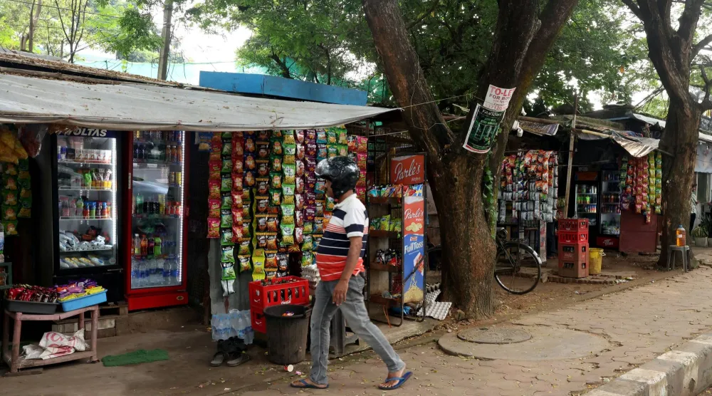 A man walks near a grocery shop in Bhubaneswar, Odisha, India, September 18, 2026. REUTERS/Priyanshu Singh