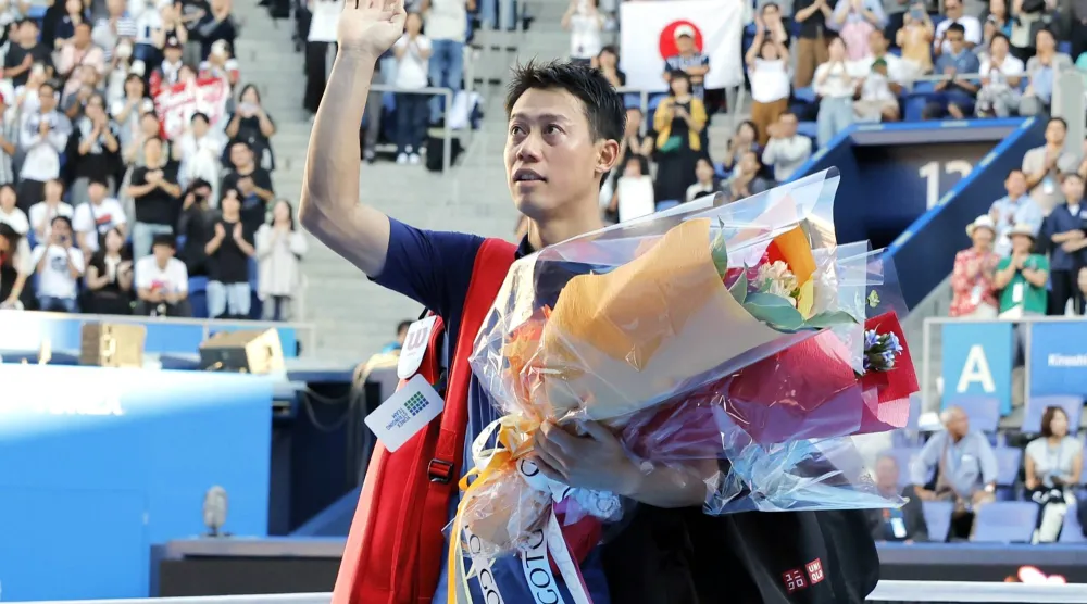 Japan's Kei Nishikori waves to the spectators after his first round loss to Frances Tiafoe at the Japan Open tennis in Tokyo, Thursday, Oct. 1, 2026. (Daiki Katagiri/Kyodo News via AP)