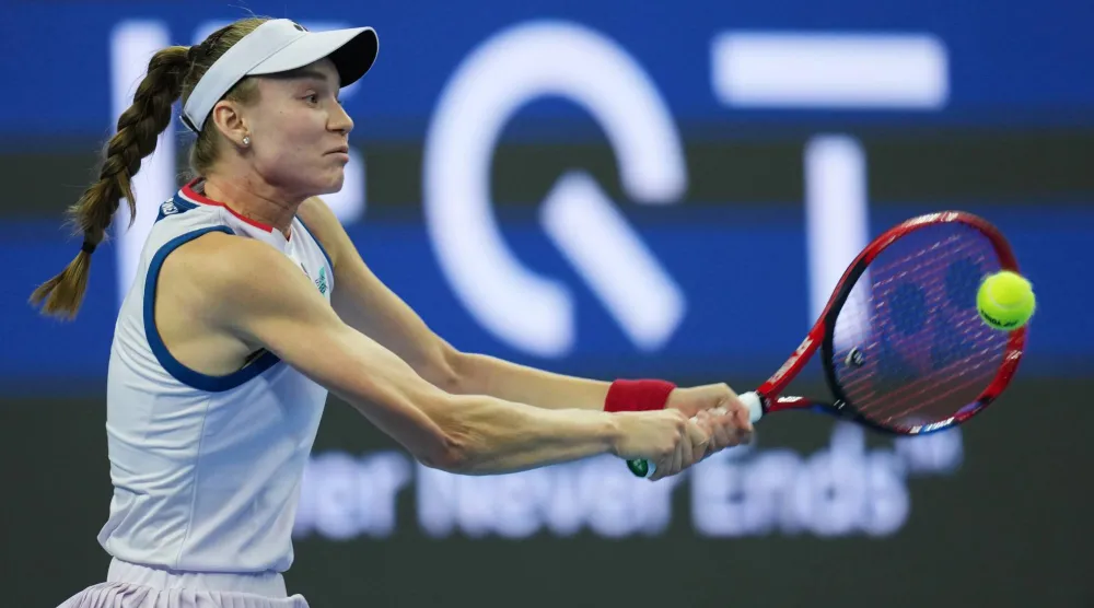 Elena Rybakina, of Kazakhstan, returns a ball to Alina Charaeva, of Armenia, during the second round of the women's singles match at the China Open tennis tournament in Beijing, Saturday, Oct. 3, 2026. (AP Photo/Ng Han Guan)