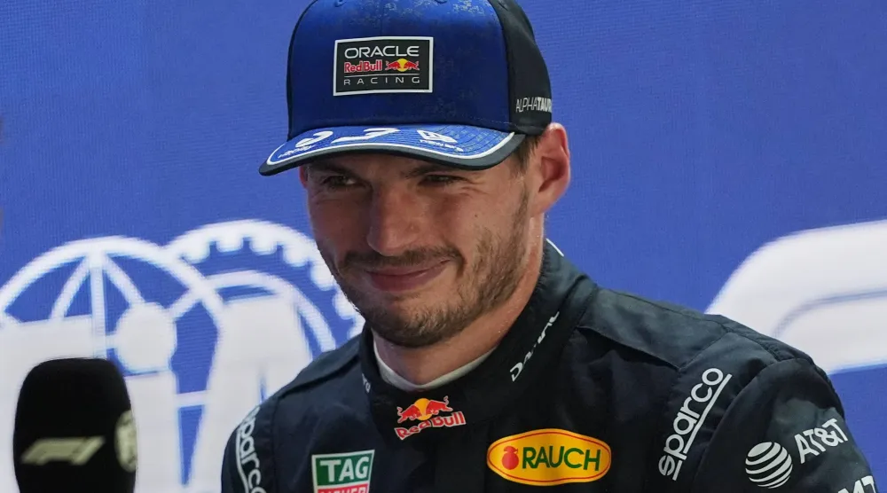 Red Bull driver Max Verstappen of the Netherlands smiles as he speaks after finishing first during the qualifying session ahead of the Singapore Formula One Grand Prix in Singapore, Singapore, Saturday, Oct. 10, 2026. (AP Photo/Ng Han Guan)