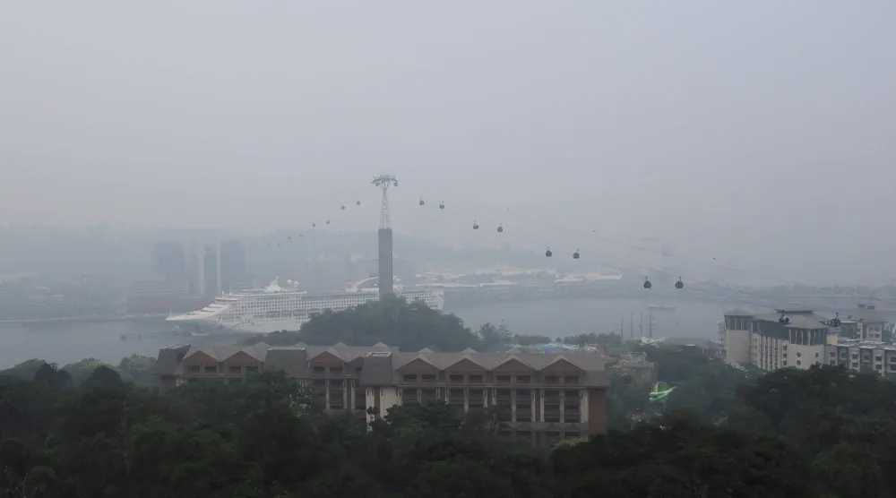 Singapore cable cars travelling towards Mount Faber station are shrouded in haze as smoke from regional forest fires reduces visibility across the city-state, in Singapore, October 14, 2026. REUTERS/Suhaimi Abdullah